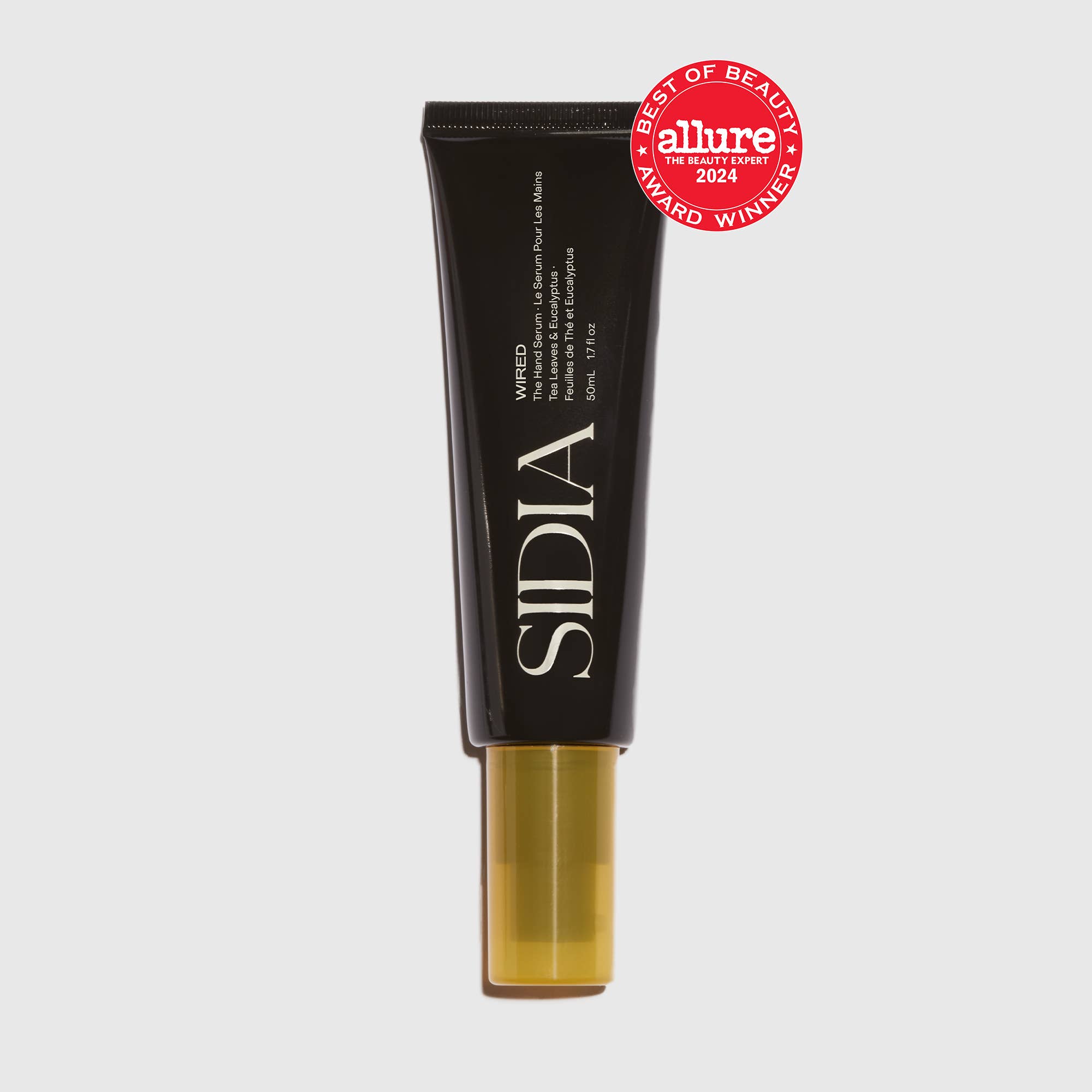 A black tube labeled "The Hand Serum by SIDIA" with a gold cap stands upright, showcasing this lightweight serum. A red Allure 2024 Best of Beauty Award Winner badge appears in the upper right on a light gray background.