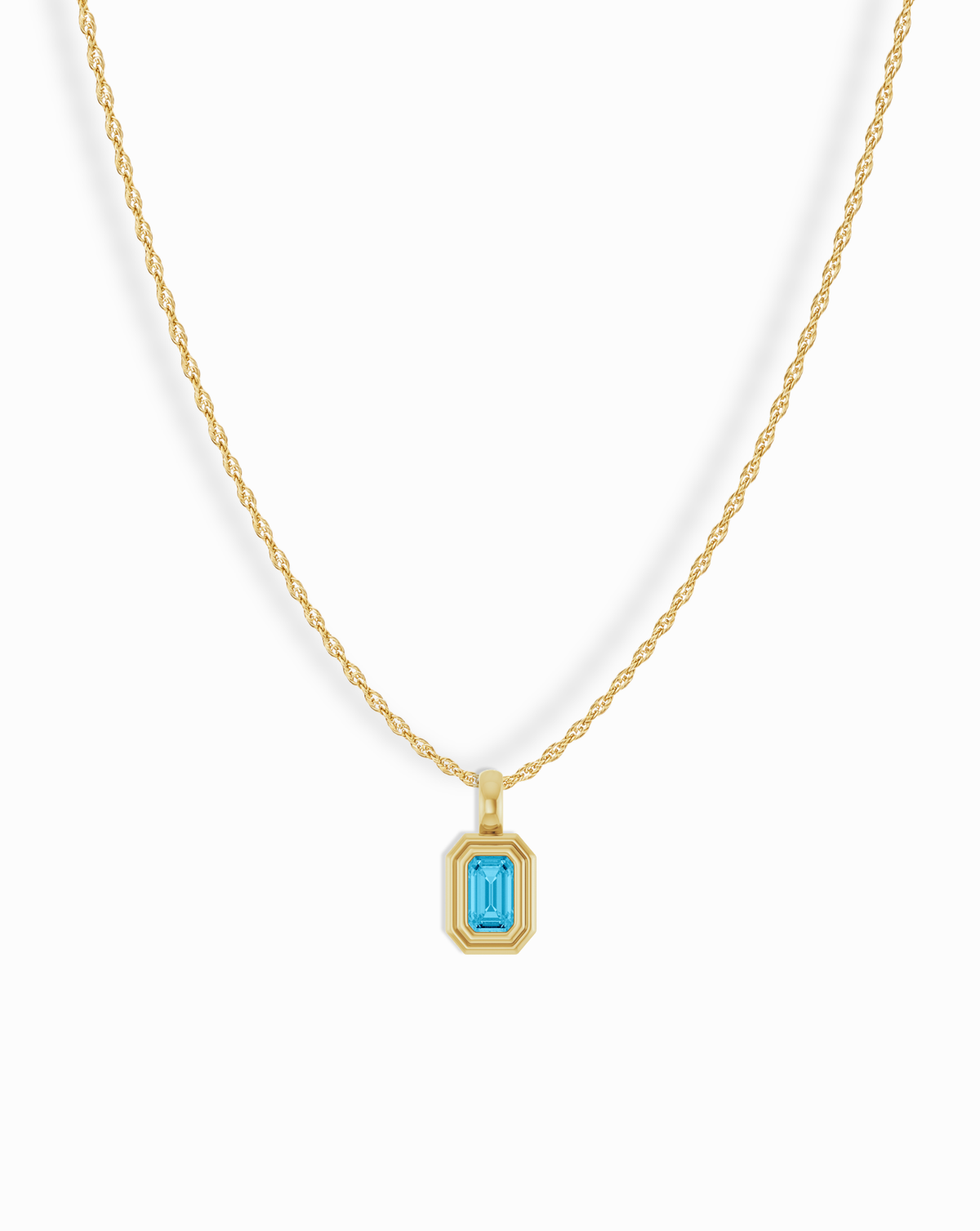 Mod + Jo 14k Birthstone Pendant Necklace featuring a gold chain and a rectangular pendant with an emerald-cut blue gemstone.