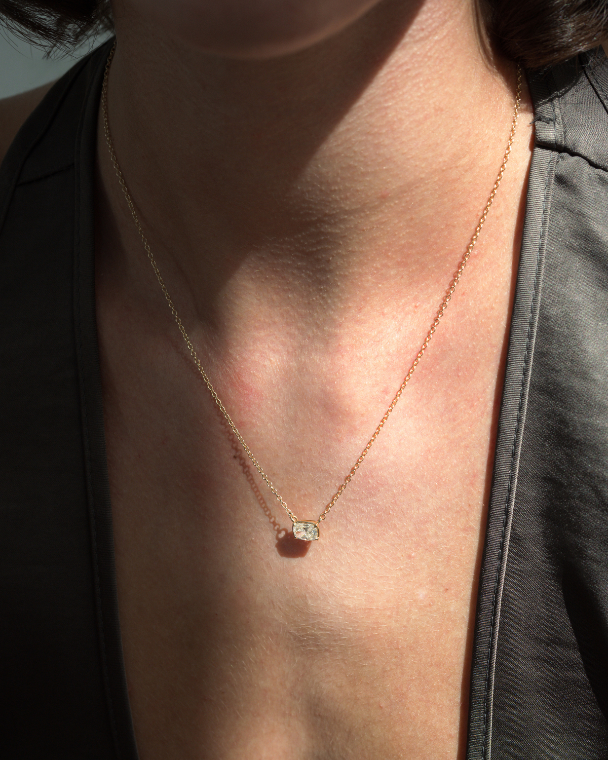 A thin 14k yellow gold 14k Cushion Cut Diamond Necklace featuring a small cushion-cut lab-grown diamond pendant centered at the collarbone.