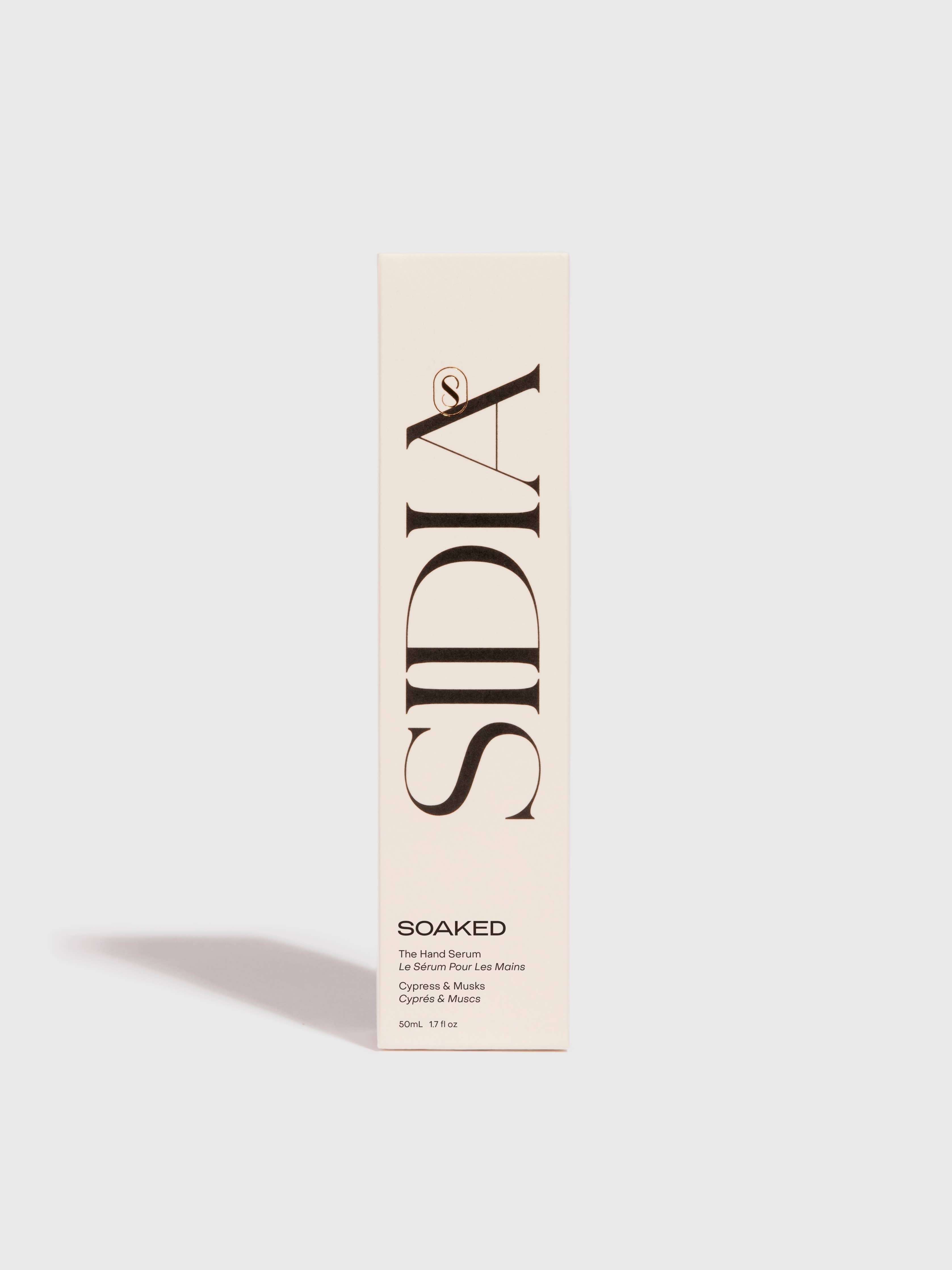 A tall, rectangular beige box with SIDIA in large black letters holds The Hand Serum by SIDIA, described as a fast-absorbing hand serum. Additional text is near the bottom. The background is plain white.