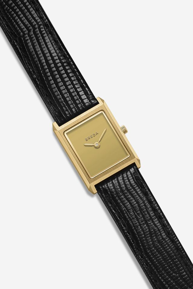 The Virgil Watch Small (Lizard Embossed) by Breda, featuring a square gold case and black lizard-embossed leather band, is displayed against a white background.