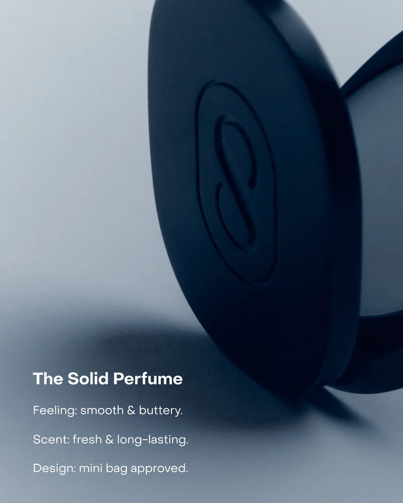 Solid perfume in a blue container on a light gray background
