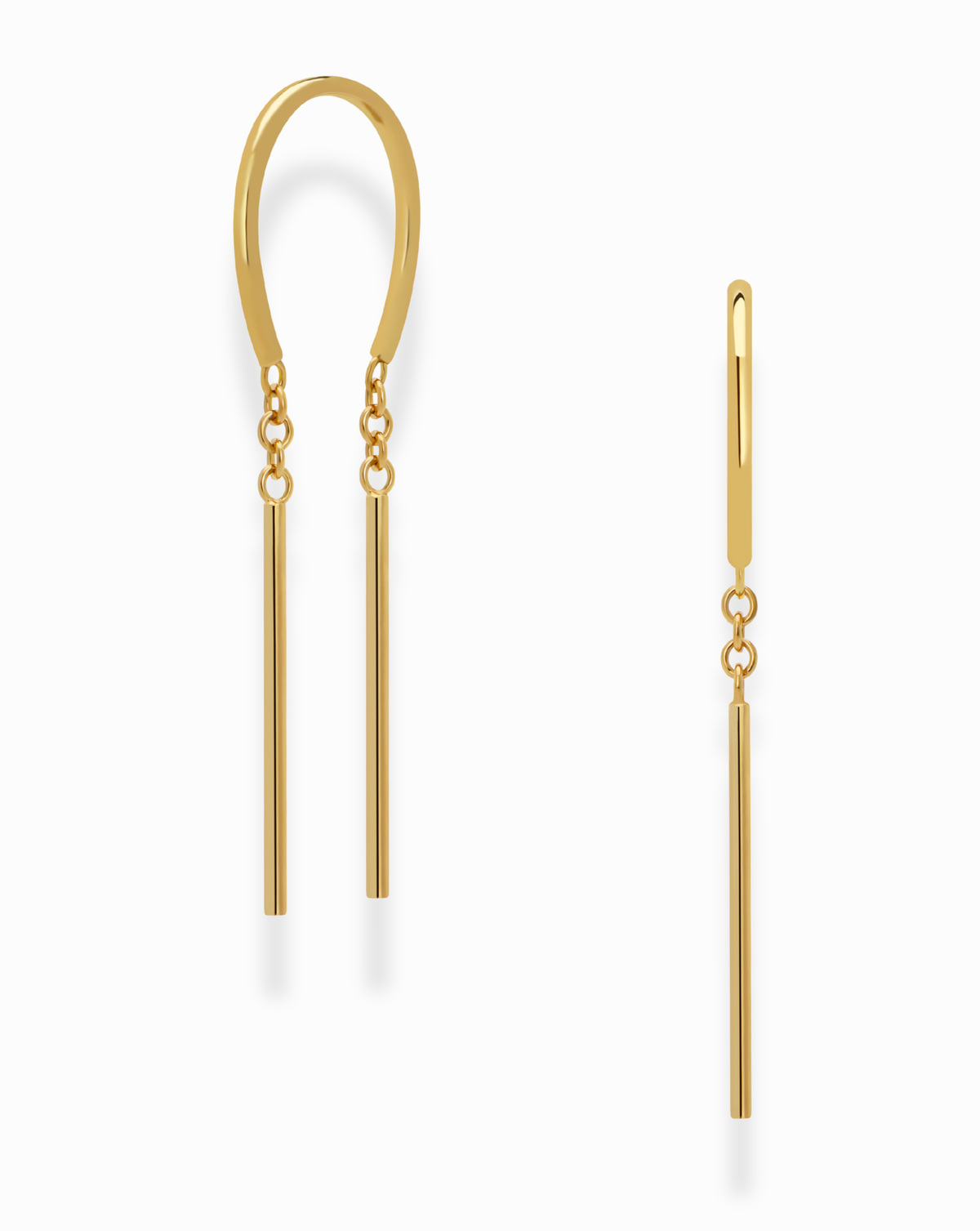 The Mila Smooth Threader Huggies by Mod + Jo are modern 14k gold hoop earrings featuring a unique curved design: one earring showcases two vertical dangling bars, while the other presents a single vertical bar. These nickel-free earrings are displayed on a white background.
