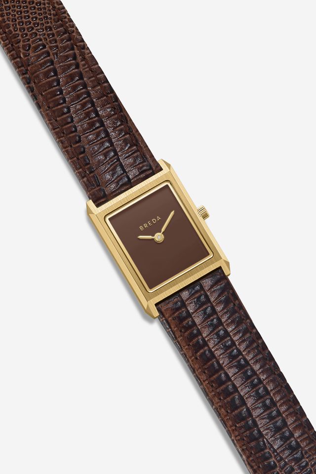 The Virgil Watch Small (Lizard Embossed) by Breda features a rectangular 18K gold-plated case, brown face, minimalist gold hands, BREDA branding, and a textured dark brown leather band, displayed diagonally on a light background.