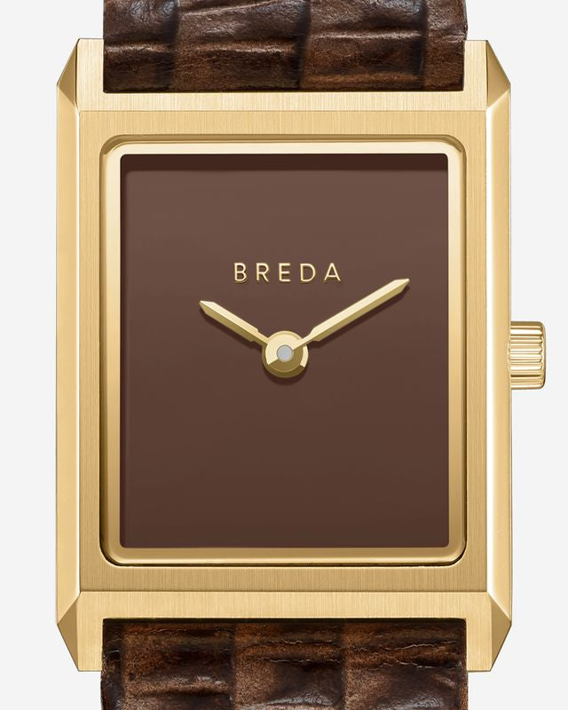 The Virgil Watch Small (Lizard Embossed) by Breda features a rectangular 18K gold-plated case, brown textured leather band, minimalist brown face with gold hands, and BREDA branding at the top. No hour markers for a sleek look.