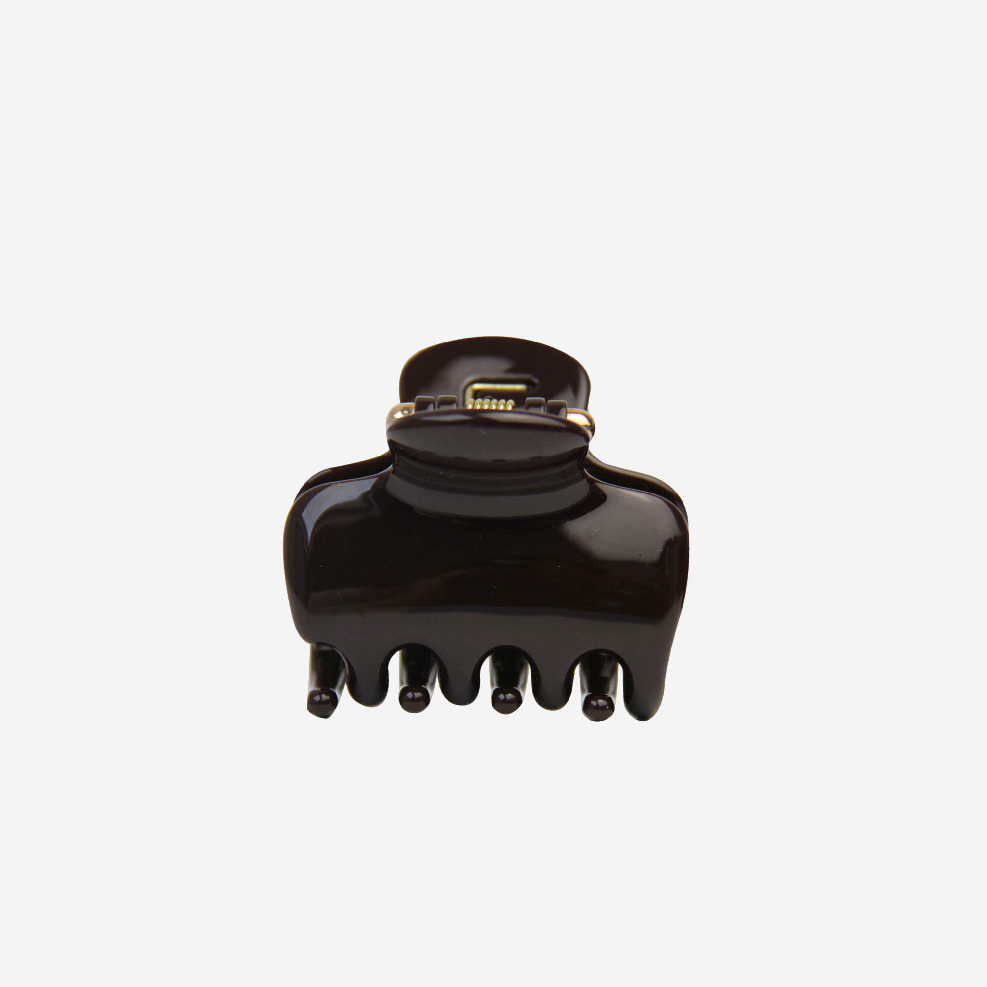 The Medium Chocolate Swirl Hair Claw by BRAID & BOW is a versatile hair accessory crafted from durable plastic with a stylish brown swirl design, featuring a hinge and five rounded prongs for strong, secure hold. It is shown against a plain white background.