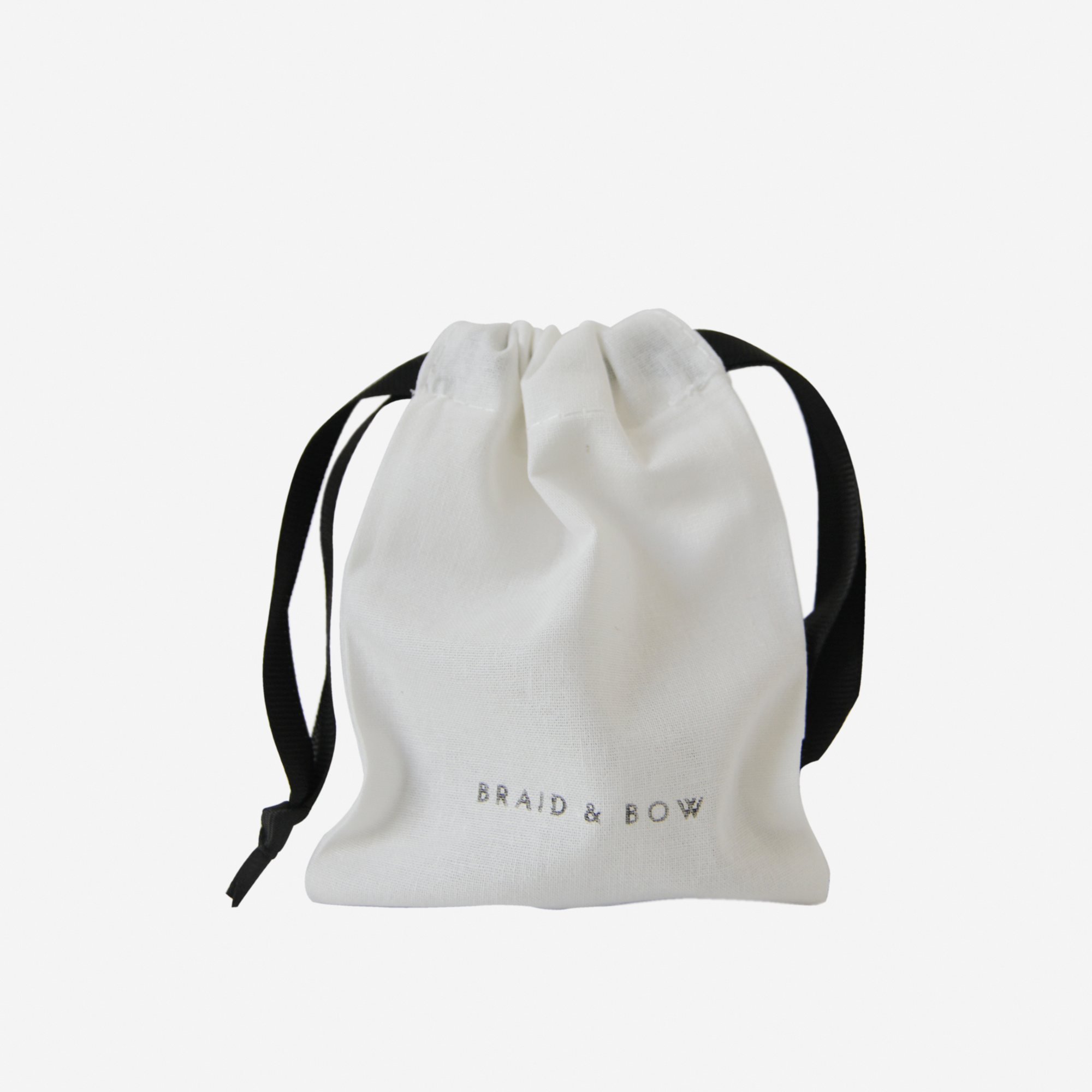 A white drawstring pouch with black ribbons and “BRAID &amp; BOW” printed in gray on the front, perfect for keeping your Medium Burgundy Swirl Hair Claw from BRAID &amp; BOW safe and secure wherever you go.
