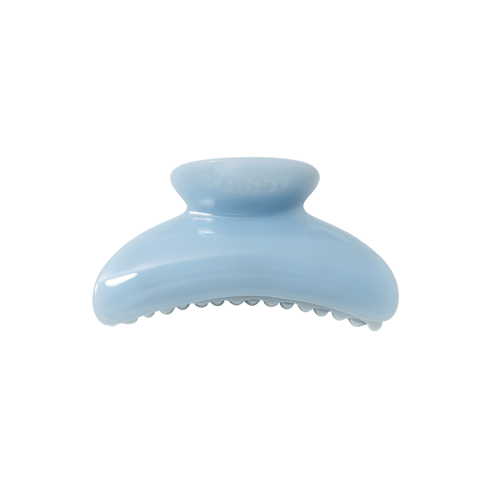 The Karst Essentials SuperClip Hair Claw — Mist: No Charm Eyelet (Standard) is a light blue, curved cellulose acetate clip with a smooth finish and interlocking teeth, offering durable hair hold. Photographed on a plain white background.
