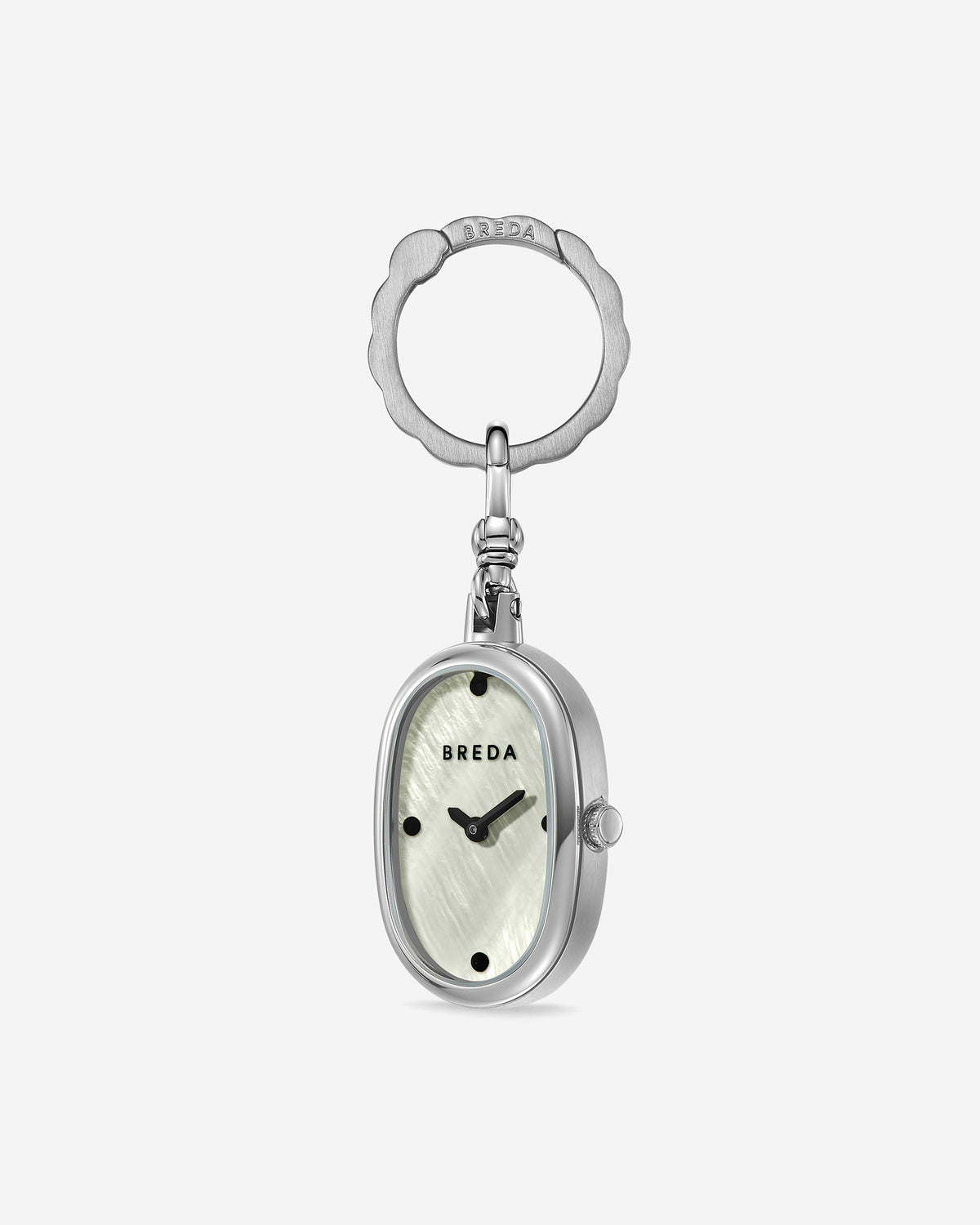 Introducing the Jane Time Charm by BREDA: an oval-shaped watch keychain featuring a silver frame, a white textured face reminiscent of mother of pearl, black hour markers, and subtle BREDA branding. Attached to a decorative silver keyring and set against a plain white background, this accessory embodies everyday elegance and versatility.