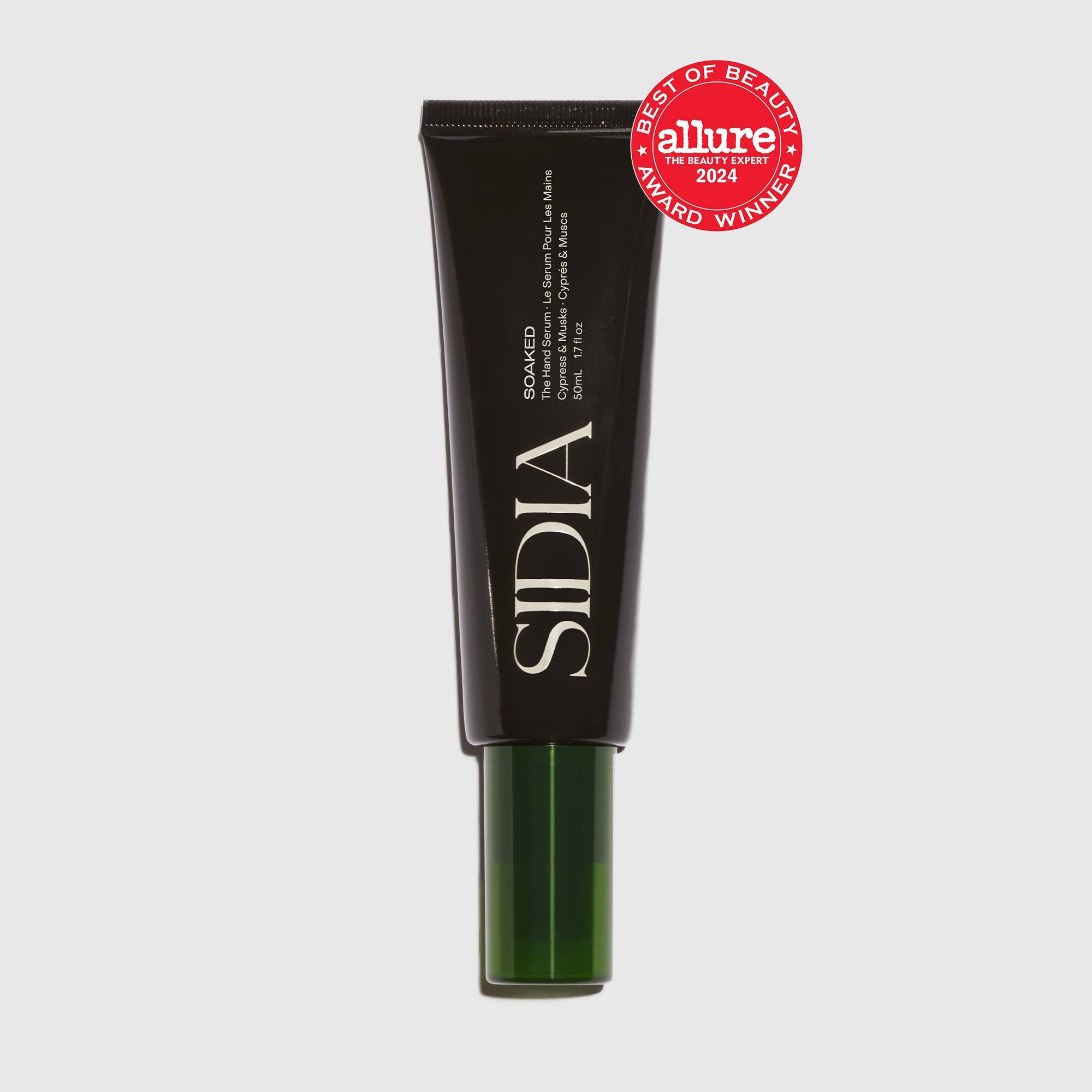 A black and green tube labeled “The Hand Serum by SIDIA” with white text and a red Allure 2024 Best of Beauty Award badge in the top right corner displays this fast-absorbing hand serum on a light gray background.