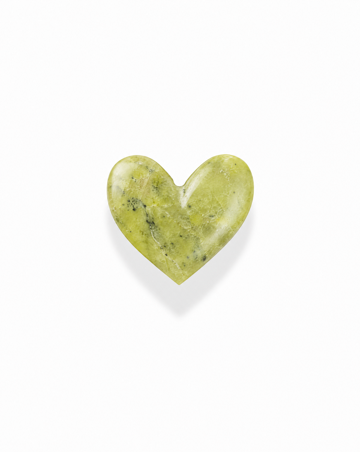A smooth, heart-shaped Davie Heart Birthstone in shades of light green with dark speckles.