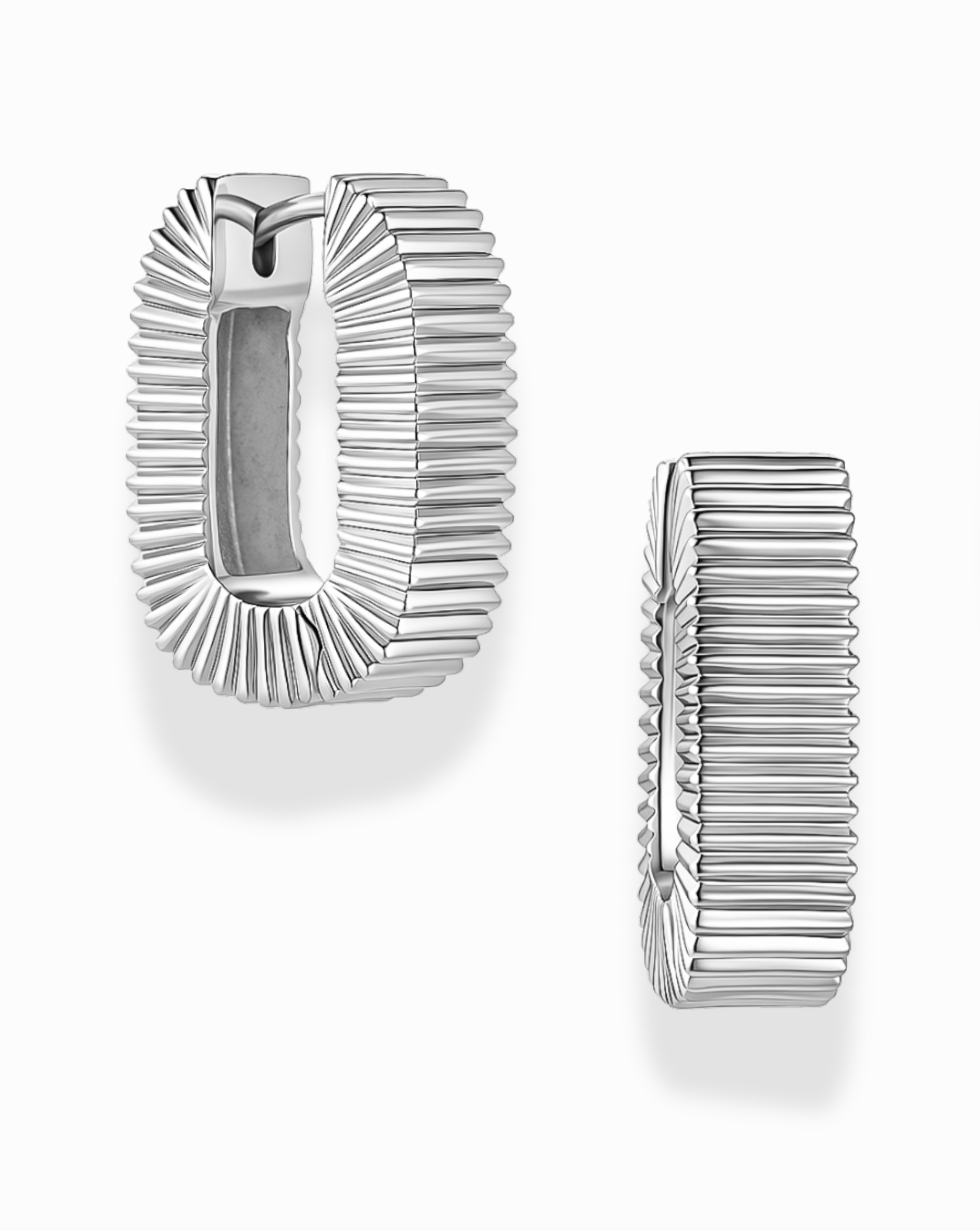 Two Elly Fluted Hoops by Mod + Jo are displayed on a white background. One earring is shown from the front, highlighting its silver rectangular hoop shape and ribbed, textured surface reminiscent of classic fluted designs, while the other earring is shown from the side.