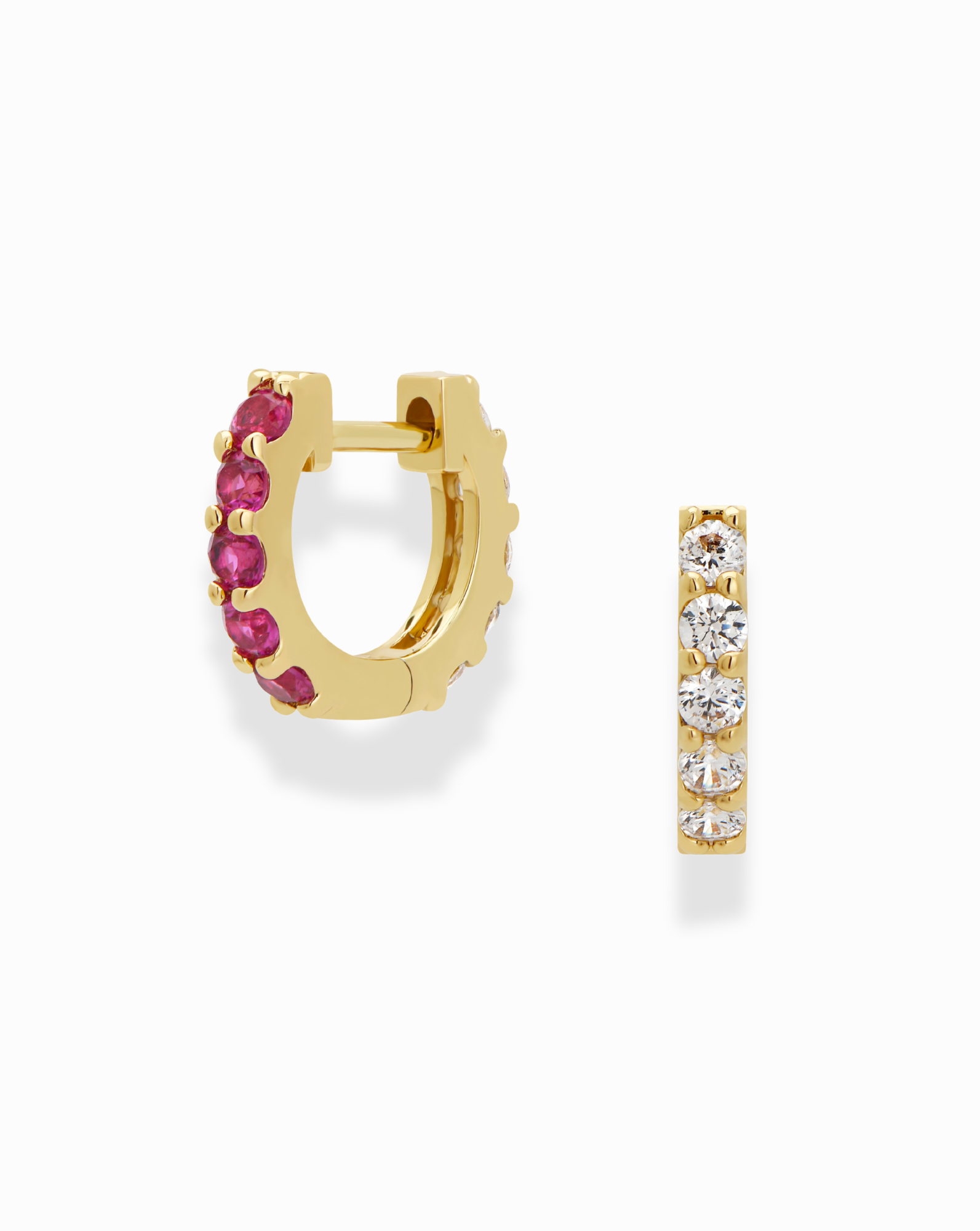 The Harlow Reversible Birthstone Huggies by Mod + Jo are small gold-plated hoops, featuring red gemstones on one side and clear white stones on the other, shown side by side against a white background.