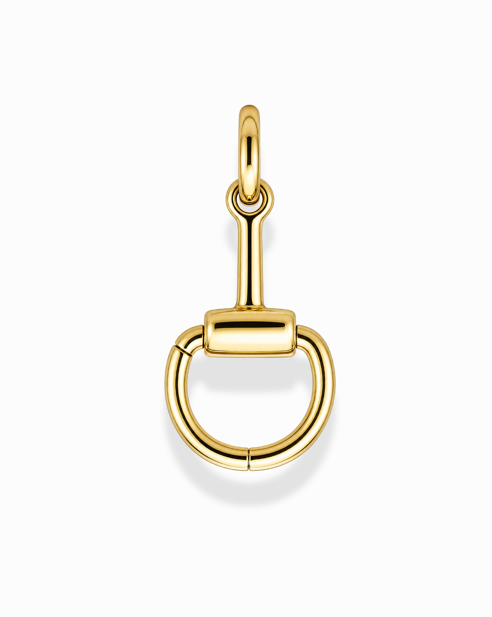 The Paige Horsebit Charm Enhancer by Mod + Jo is a 14k gold-plated, nickel-free, and tarnish-resistant pendant designed in the shape of a snaffle bit, featuring a circular lower section with a straight horizontal bar at the top. Photographed on a plain white background, this piece ensures both elegance and lasting shine.