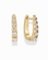 Jules Grande Huggies by Mod + Jo: a pair of 14k gold-plated huggie hoop earrings featuring a row of prong-set cubic zirconia stones along the front.