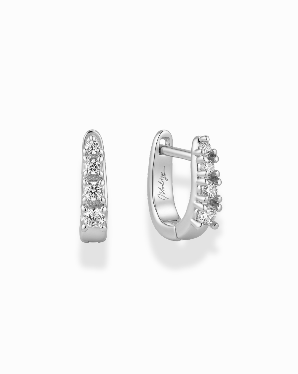 Jules Petite Huggies: tarnish-resistant silver huggie hoop earrings, each featuring a row of four small round cubic zirconia stones.
