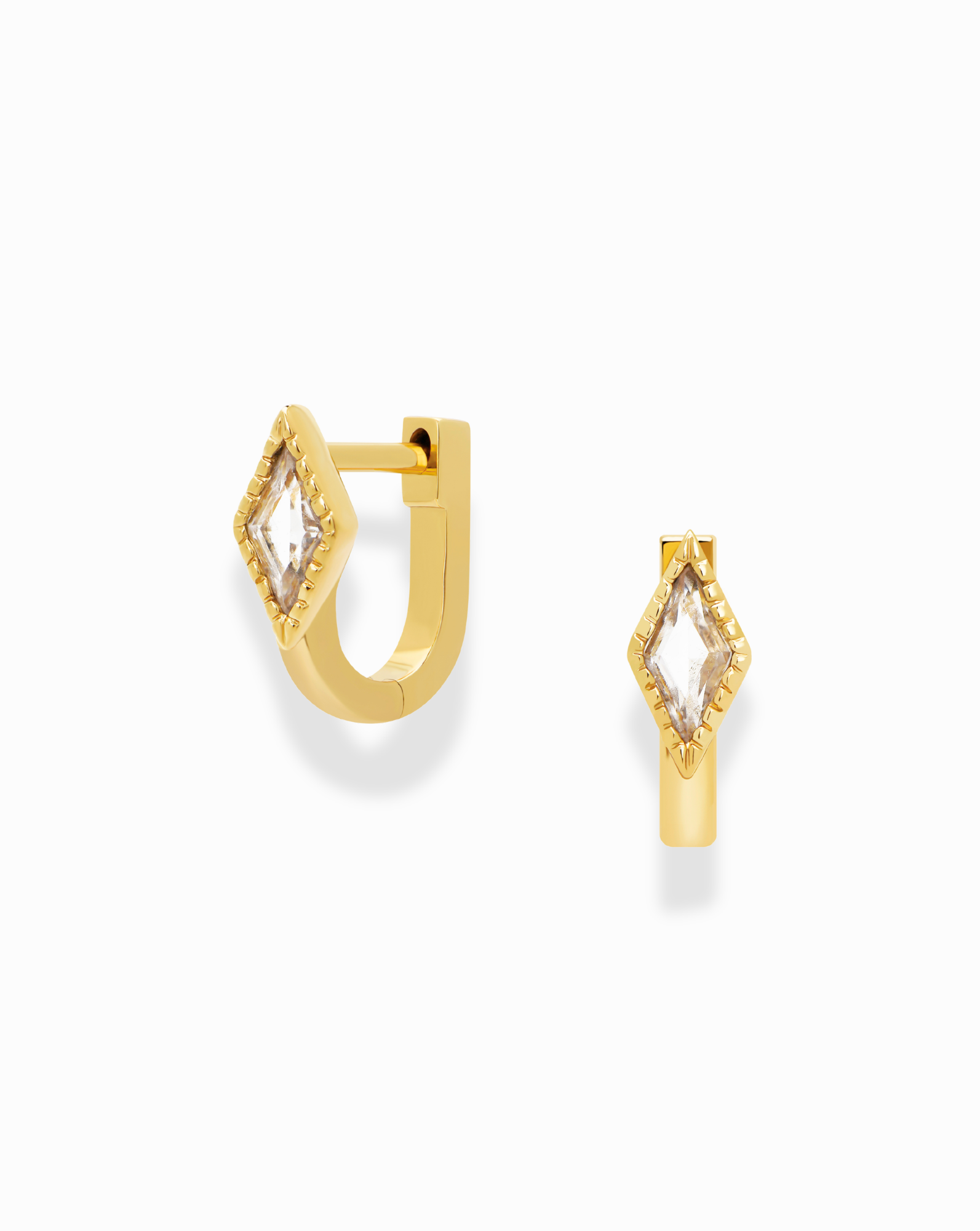 Introducing the Phoebe Kite Huggies by Mod + Jo, a pair of gold-plated earrings with a contemporary, minimalist silhouette. Each earring showcases a central, diamond-shaped cubic zirconia for added elegance. These stylish huggies are displayed against a plain white background.
