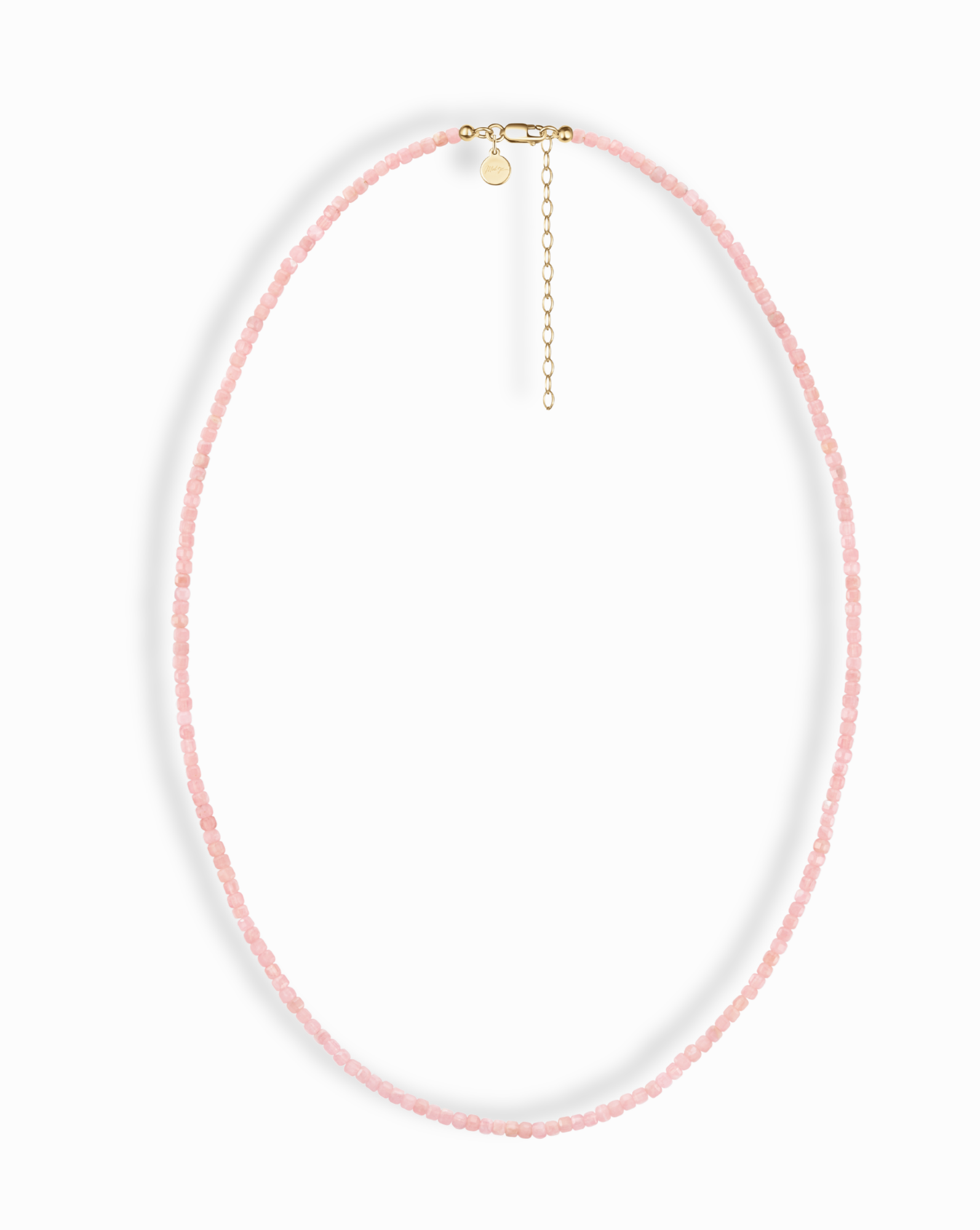 The Merit Gemstone Necklace by Mod + Jo features delicate pink round beads, a gold clasp, and an adjustable extender chain, shown on a white background.
