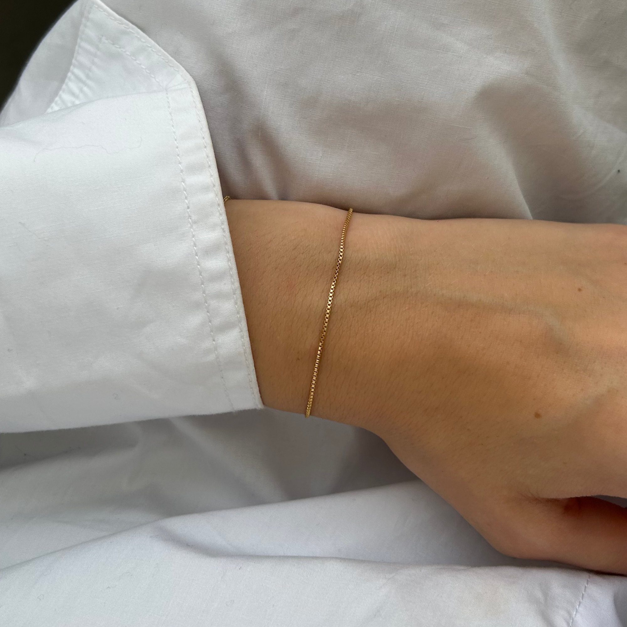 delicate gold chain bracelet on wrist | Mod + Jo