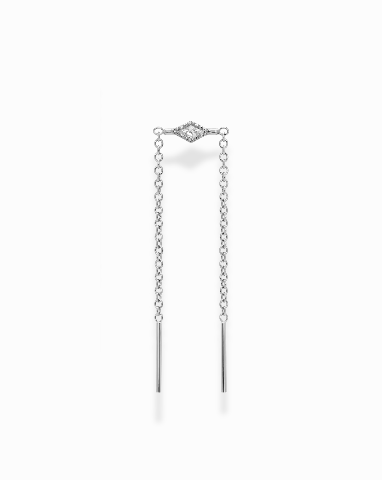 The Nicole Kite Threader Earring by Mod + Jo features a central marquise-shaped setting embellished with sparkling cubic zirconia stones, all crafted in a sleek rhodium-plated finish. Two delicate chains extend from the centerpiece, each ending in a thin bar. The earring is presented against a plain white background.