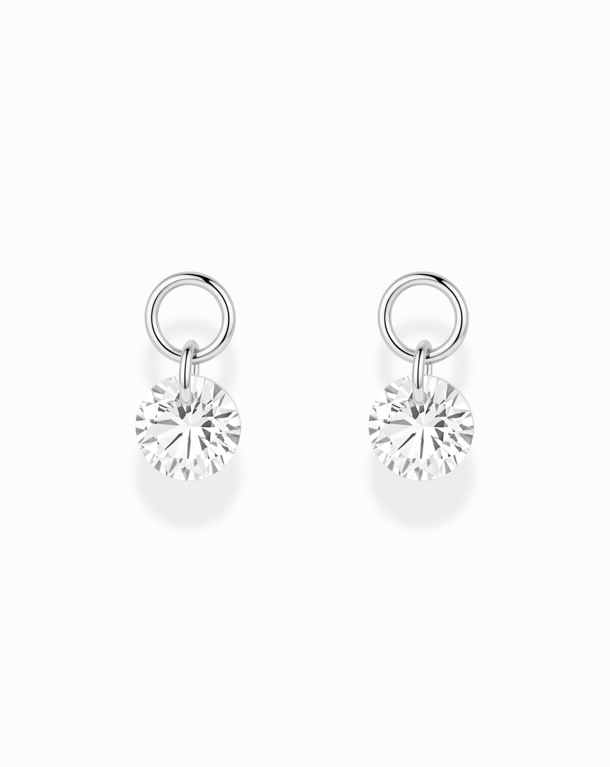 Noa Sapphire Earring Charms consisting of a pair of silver hoop charms, each featuring a faceted, lab-grown white sapphire in a floating setting.