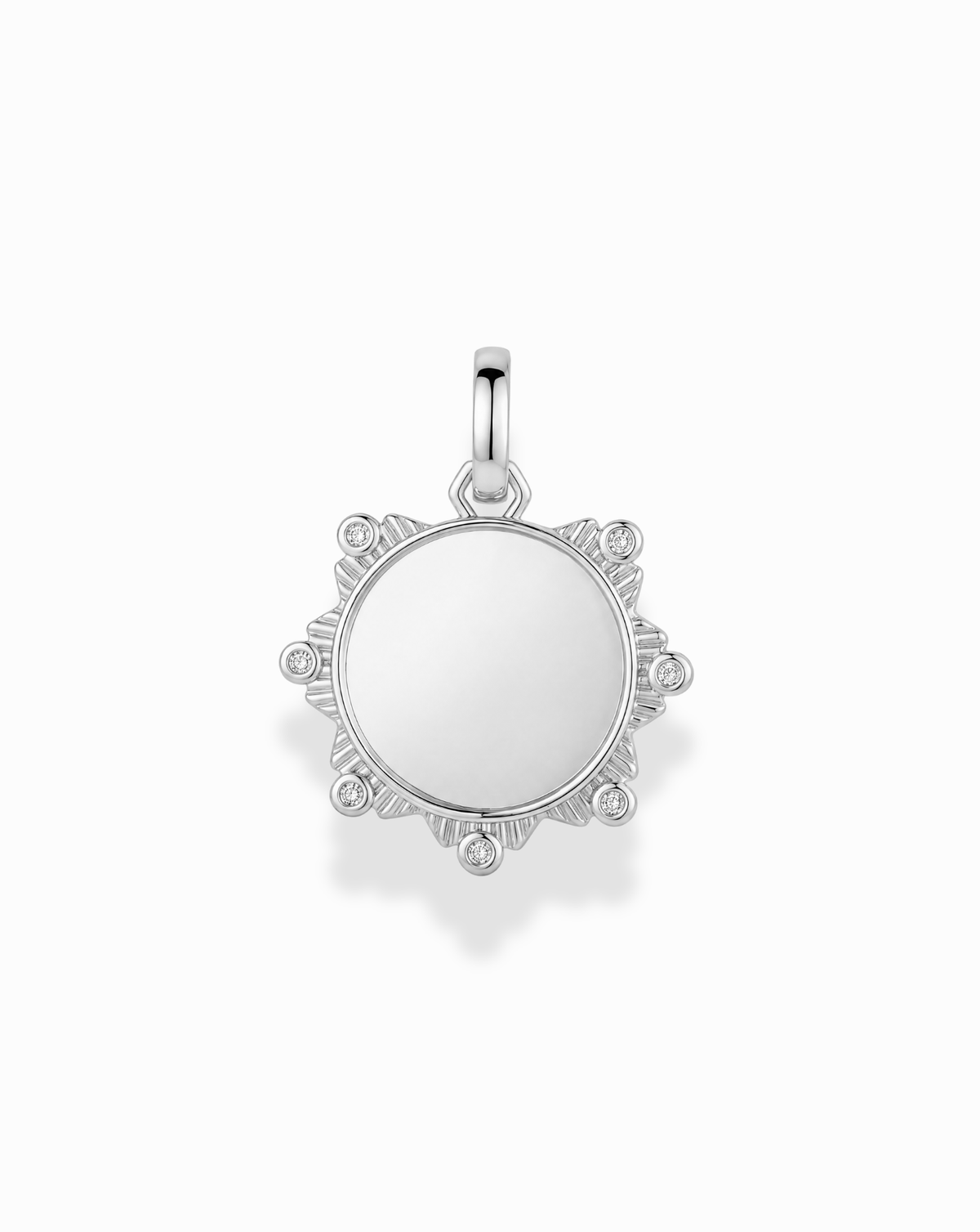 Remi Engravable Charm: a round silver-plated charm with a smooth center and sunburst-style rays accented with small inset cubic zirconia.