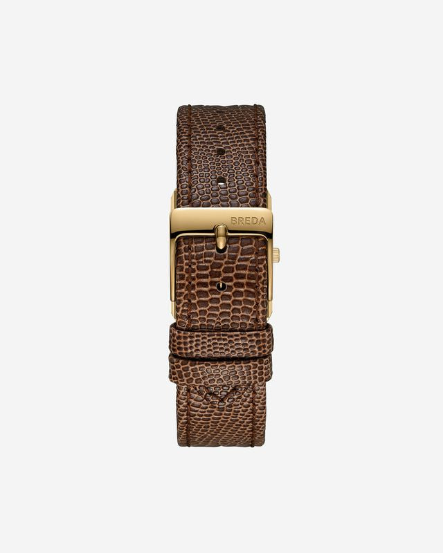 A close-up of the BREDA Virgil Watch Small (Lizard Embossed) highlights its brown textured leather band and gold-plated buckle engraved with BREDA, displaying elegant 18K gold plating against a plain white background.