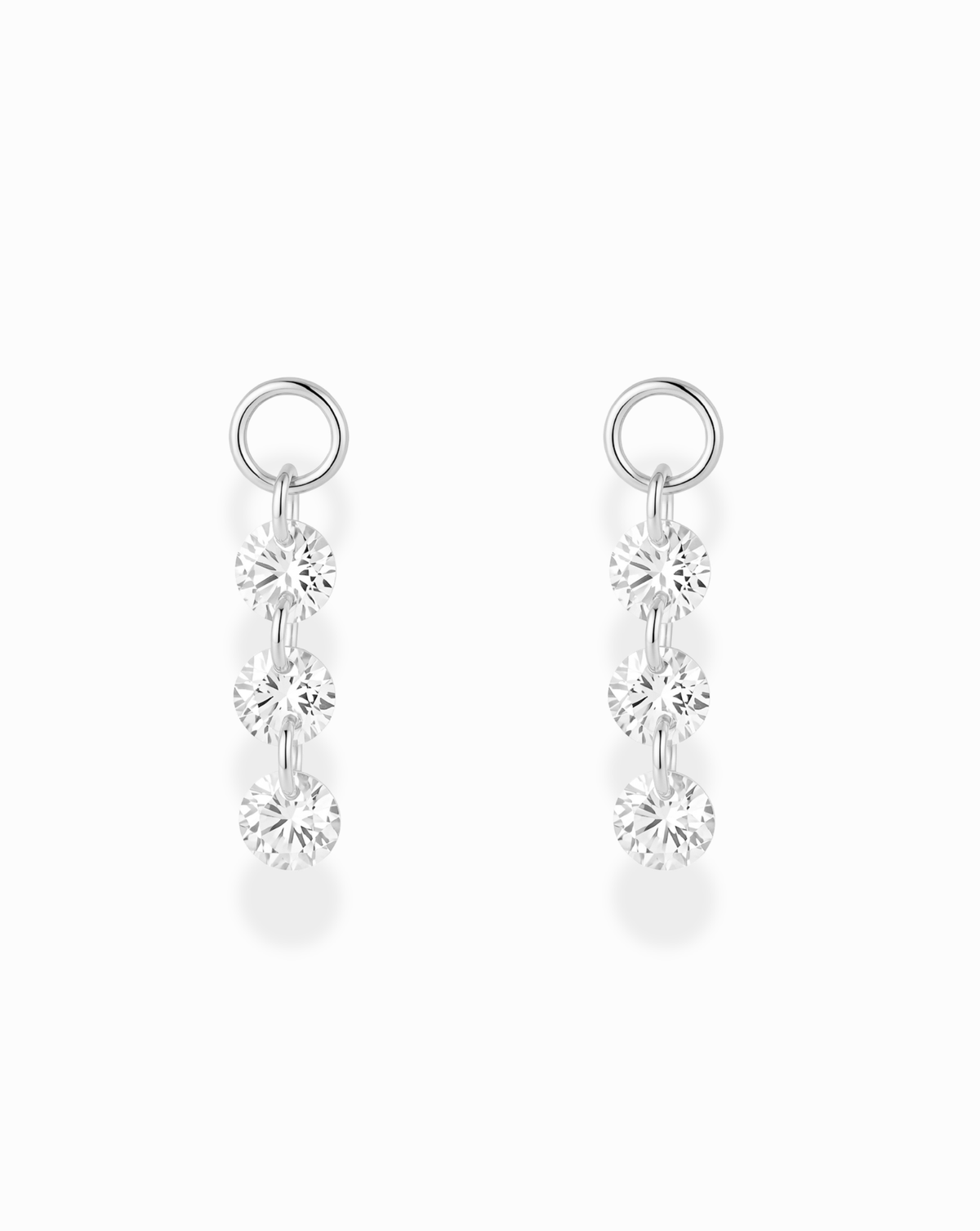 Mod + Jo Sade Sapphire Earring Charms featuring three lab-grown white sapphires in a floating setting, suspended vertically from a silver ring.