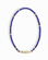 The Sonia Gemstone Necklace by Mod + Jo features small, round blue lapis lazuli beads with gold spacer beads and a gold clasp, displayed in an oval shape on a white background.