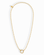 Introducing the Soren Ball Charm Clip Necklace by Mod + Jo: a gold-plated ball chain necklace featuring a circular ring pendant at the center. This 14k gold necklace forms an elegant oval shape, finished with a small round charm attached near the clasp. Photographed on a white background.