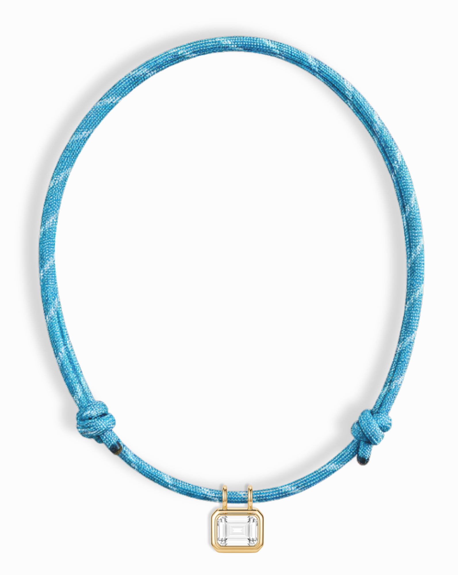 The *Preorder* Tommy Sapphire Pendant Necklace by Mod + Jo features a rectangular lab-grown white sapphire set in gold on a blue adjustable paracord with side knots.